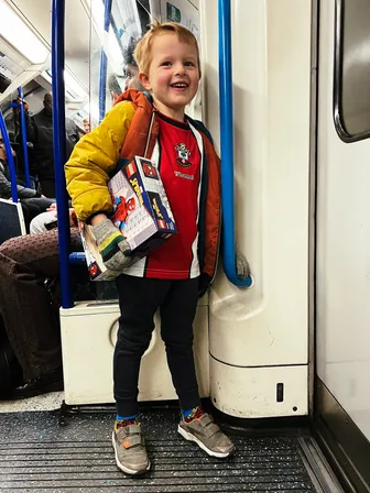 Photo of my nephew on the tube holding his new lego set