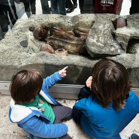 My daughter pointing out the butt of a mummified man